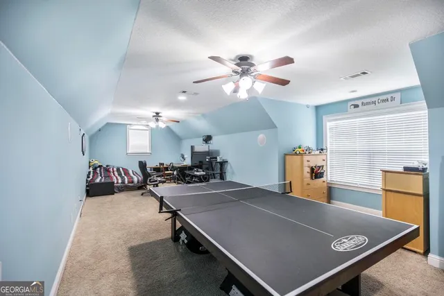 a room with gym equipment and a chandelier