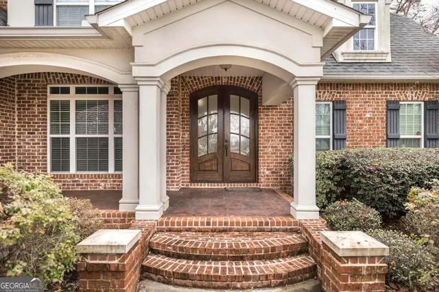 a view of a house with entrance gate and two windows