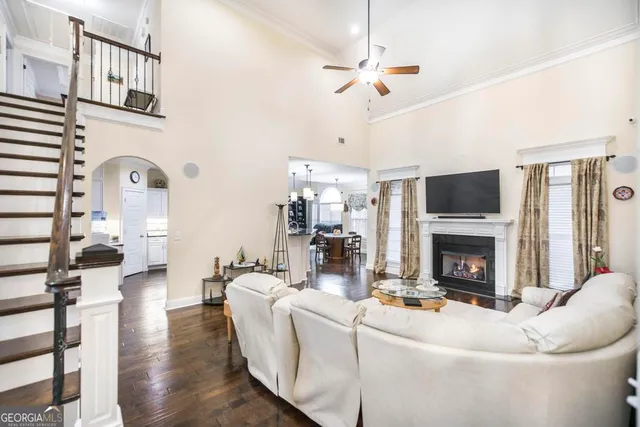 a living room with furniture a fireplace and a chandelier