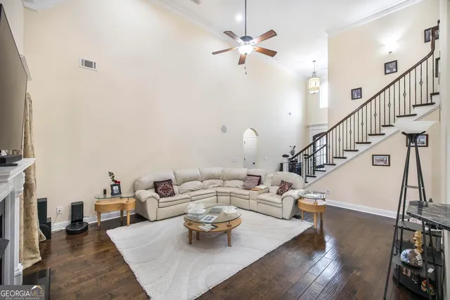 a living room with furniture and a chandelier