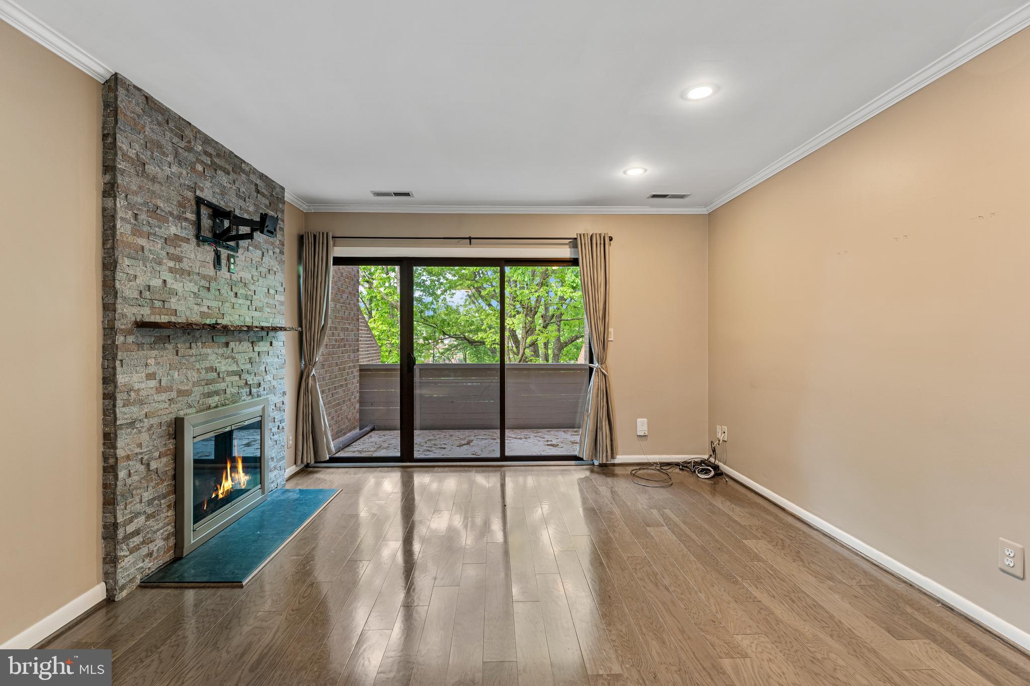 11120 Harbor Court, Unit 1120 Reston, VA 20191 - Photo 16 of 26 a view of empty room with wooden floor and fireplace