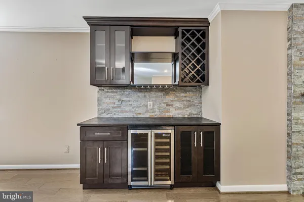 a view of empty room with wooden floor and fireplace