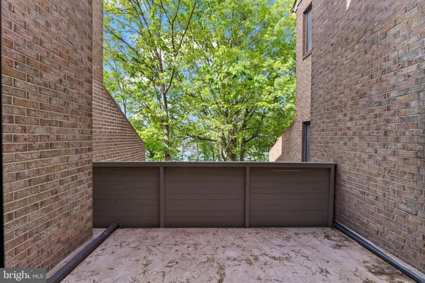 a view of an empty room with window and fireplace