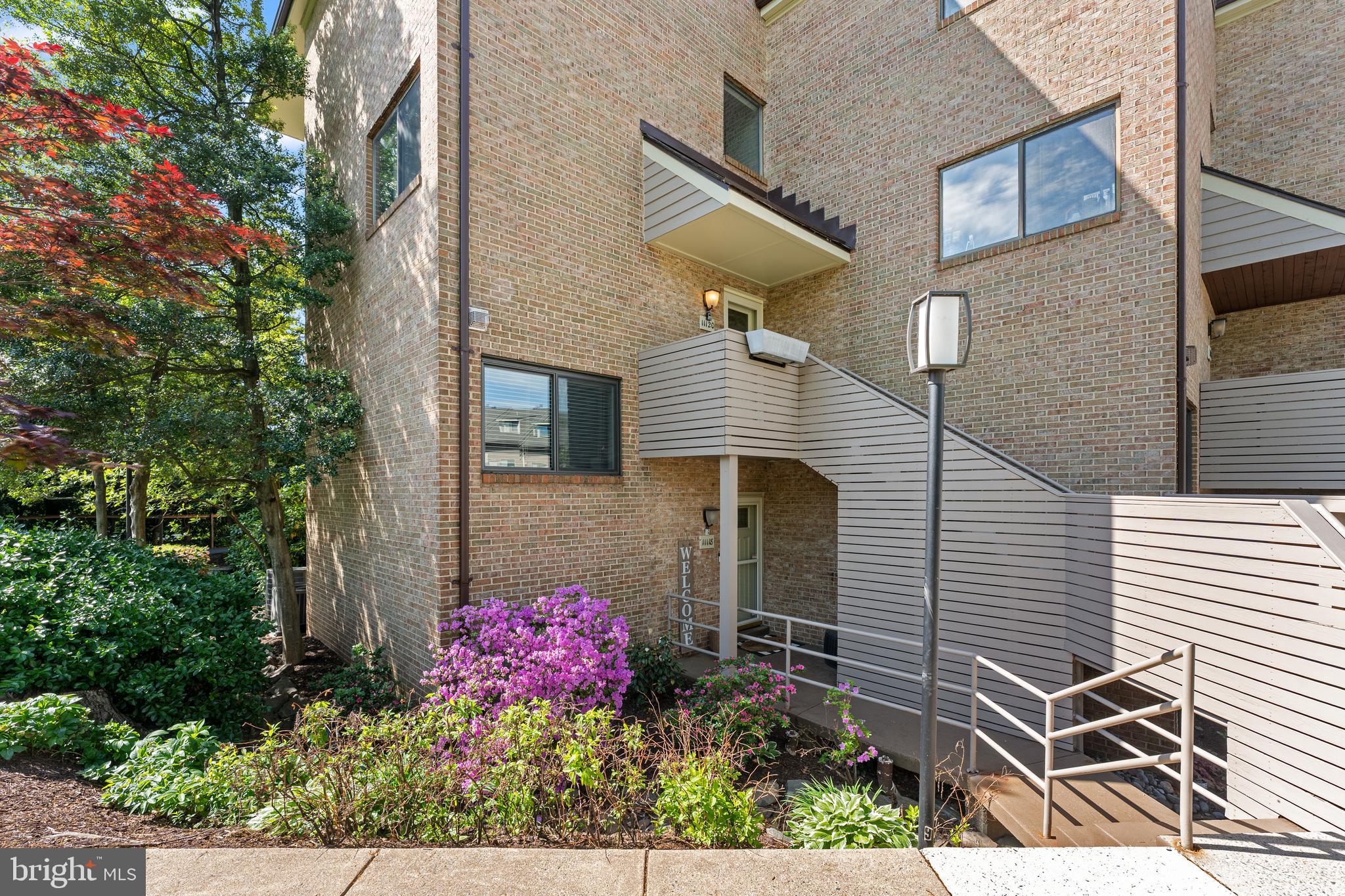 11120 Harbor Court, Unit 1120 Reston, VA 20191 - Photo 2 of 26 a view of a house with a yard and garden