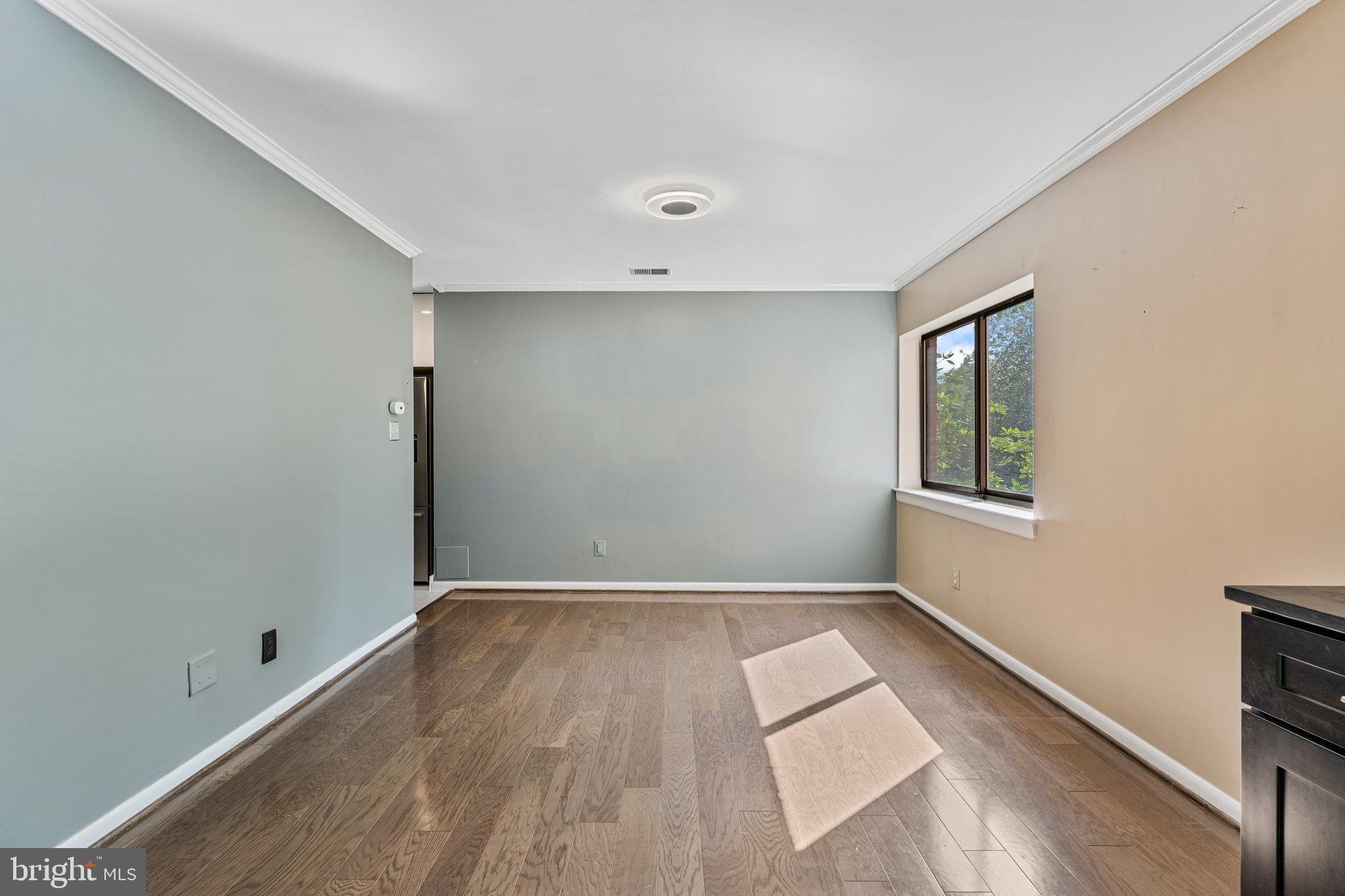 11120 Harbor Court, Unit 1120 Reston, VA 20191 - Photo 22 of 26 an empty room with wooden floor and windows