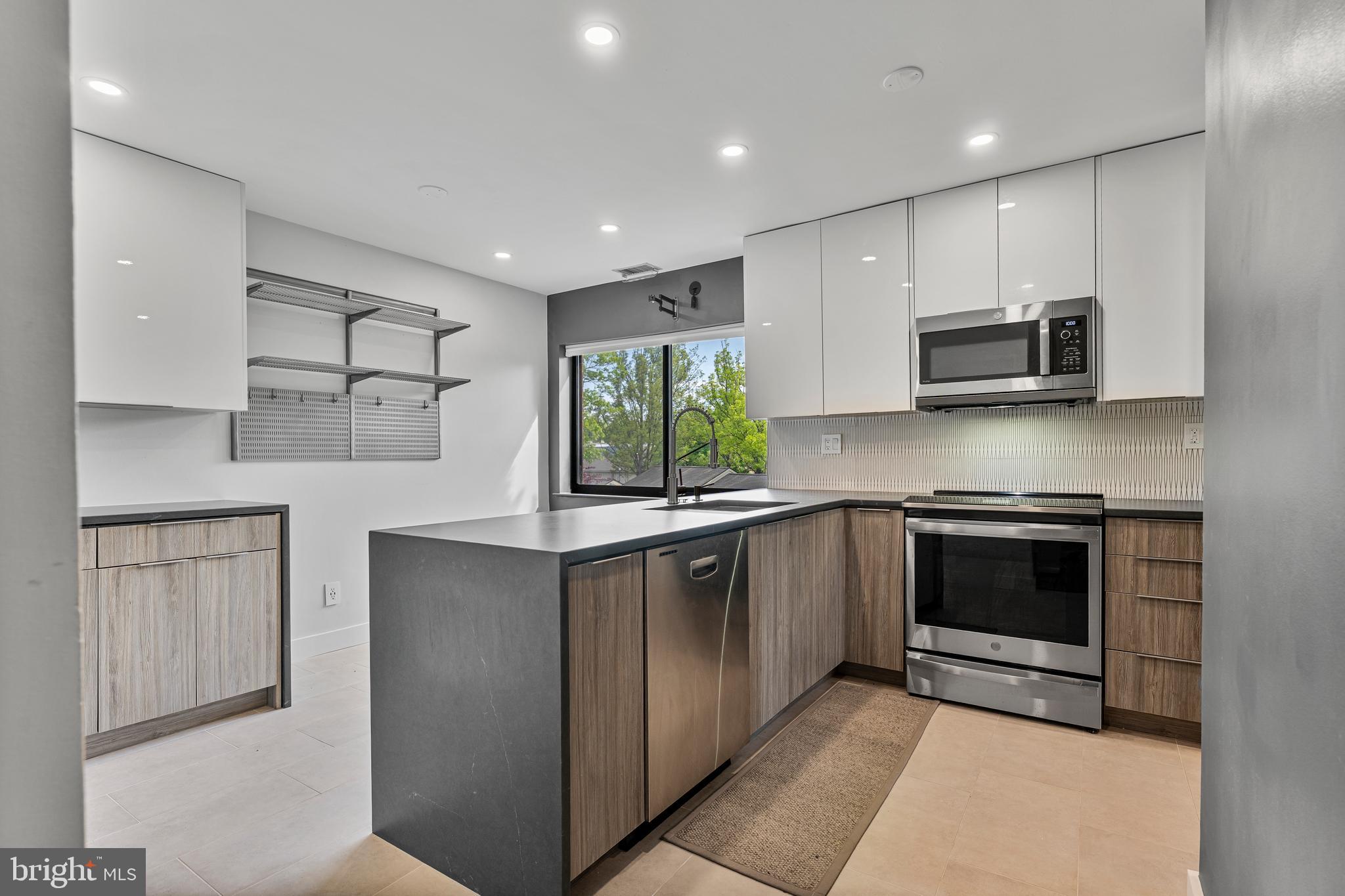 11120 Harbor Court, Unit 1120 Reston, VA 20191 - Photo 4 of 26 a kitchen with stainless steel appliances granite countertop a stove and a sink