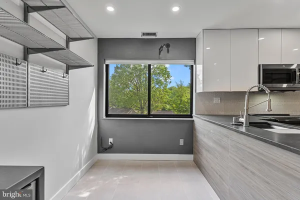 a kitchen with granite countertop a stove and a sink