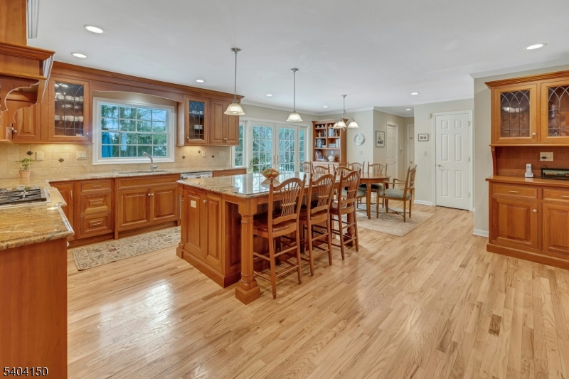 31 Garfield Avenue Madison, NJ 07940 - Photo 16 of 47 a kitchen with stainless steel appliances granite countertop a table chairs sink and cabinets