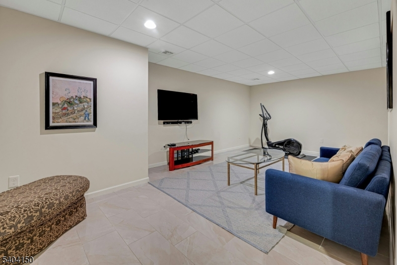 31 Garfield Avenue Madison, NJ 07940 - Photo 38 of 47 a living room with furniture and a flat screen tv