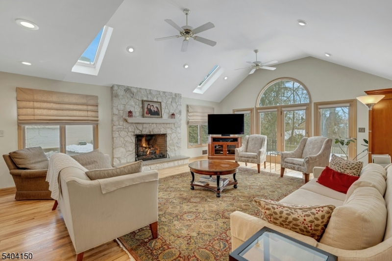31 Garfield Avenue Madison, NJ 07940 - Photo 10 of 47 a living room with furniture a fireplace and a flat screen tv