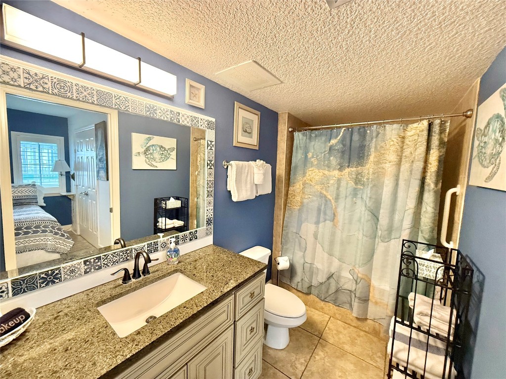 32 South Fletcher Avenue, Unit 105 Fernandina Beach, FL 32034 - Photo 8 of 16 a bathroom with a granite countertop sink toilet and shower