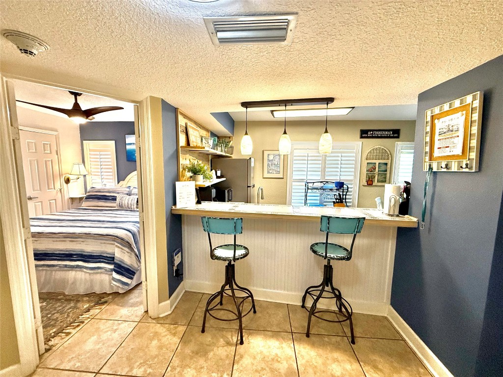 32 South Fletcher Avenue, Unit 105 Fernandina Beach, FL 32034 - Photo 10 of 16 a dining room with furniture and a floor to ceiling window