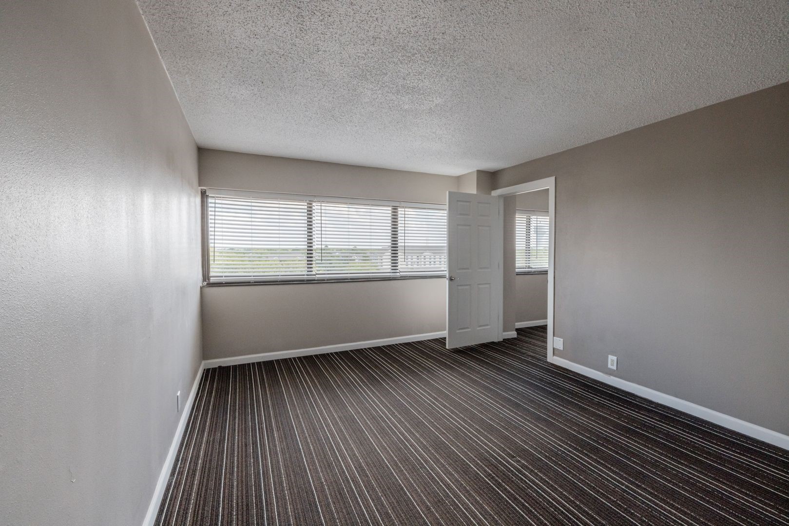 14703 Park Row Houston, TX 77079 - Photo 38 of 40 an empty room with wooden floor and windows
