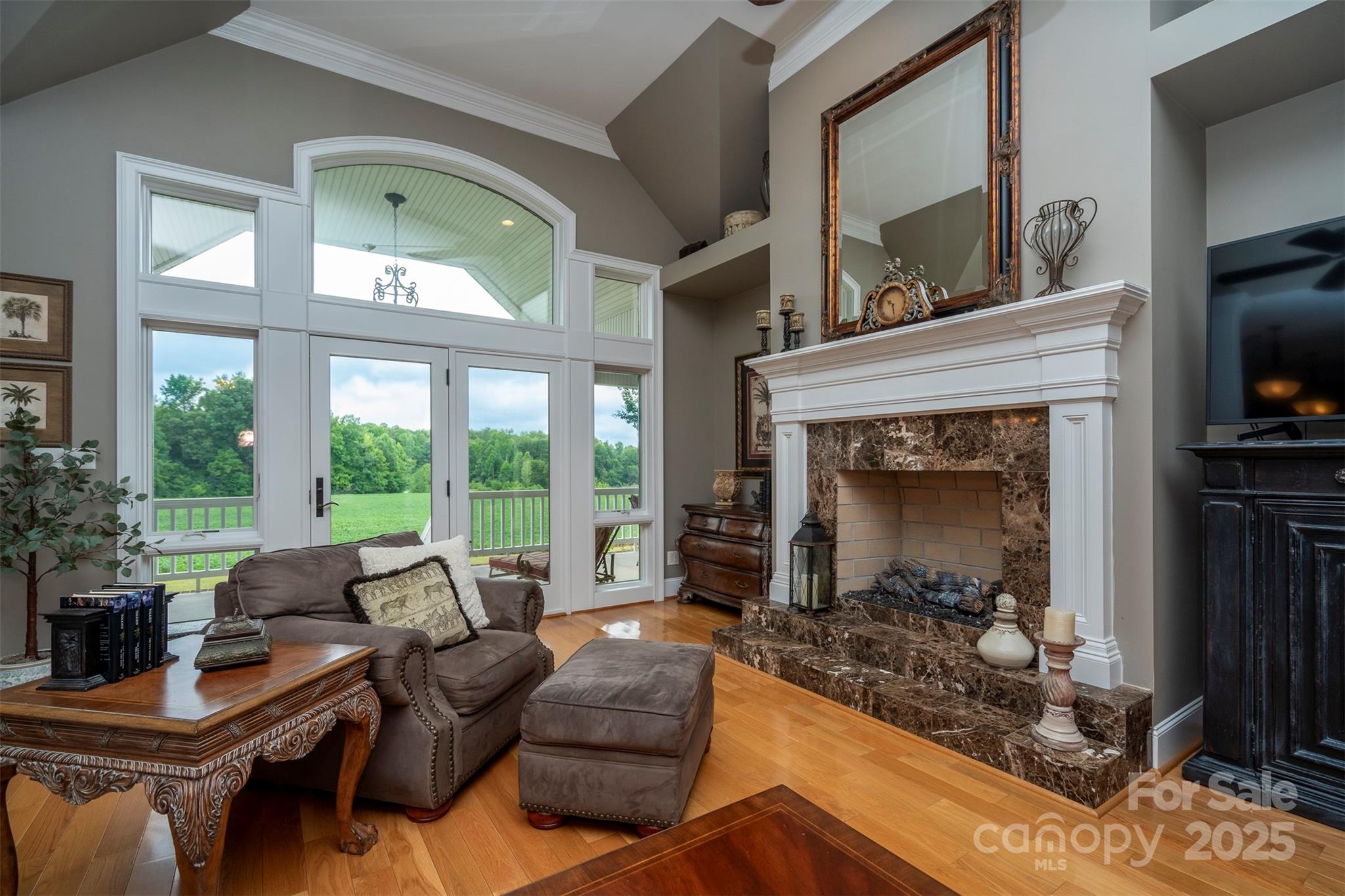 8340 Highway 801 Mount Ulla, NC 28125 - Photo 15 of 47 a living room with furniture a large window and a fireplace