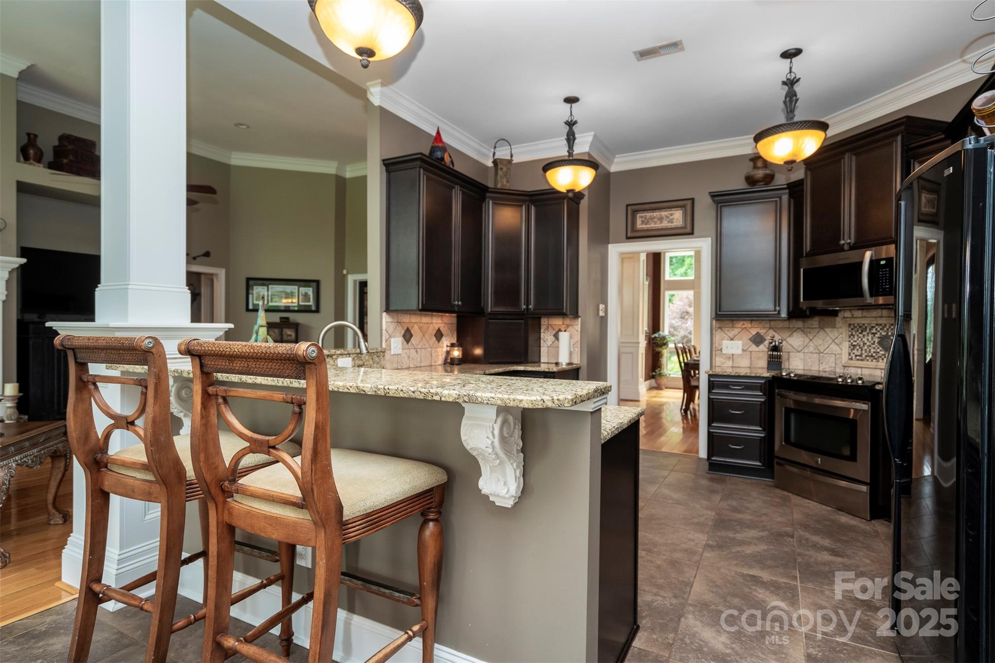 8340 Highway 801 Mount Ulla, NC 28125 - Photo 22 of 47 a kitchen with cabinets and chairs