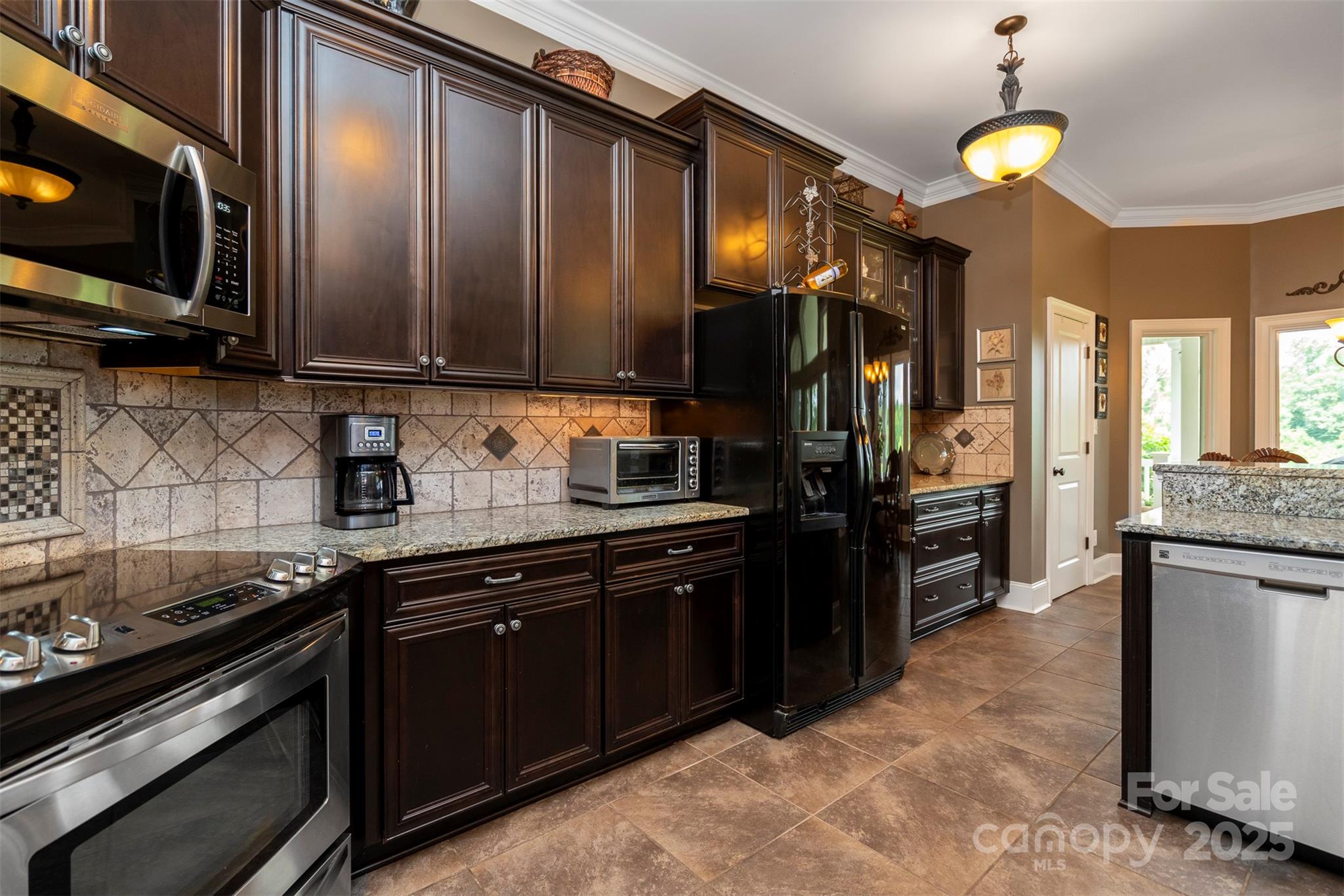 8340 Highway 801 Mount Ulla, NC 28125 - Photo 24 of 47 a kitchen with stainless steel appliances granite countertop a stove refrigerator and cabinets