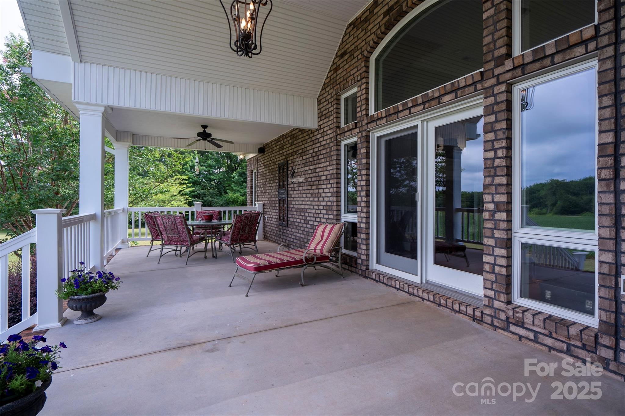8340 Highway 801 Mount Ulla, NC 28125 - Photo 37 of 47 a view of a patio with table and chairs potted plants with wooden floor and fence