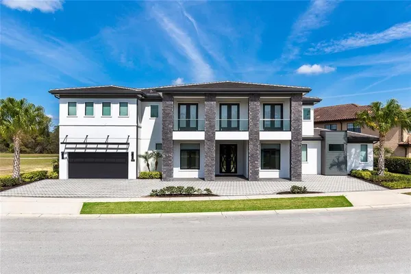 a view of house with outdoor space and swimming pool