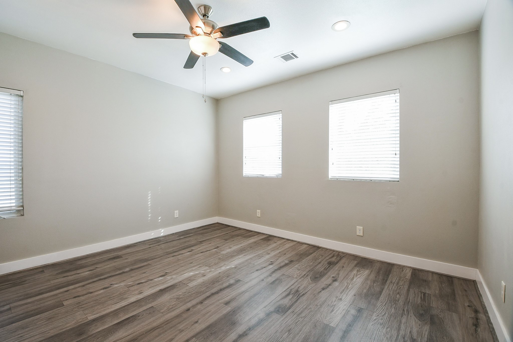 3249 Dixie Drive, Unit B Houston, TX 77021 - Photo 9 of 25 wooden floor in an empty room with a window