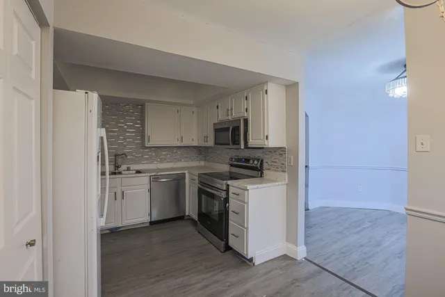 a kitchen with a sink stove and refrigerator