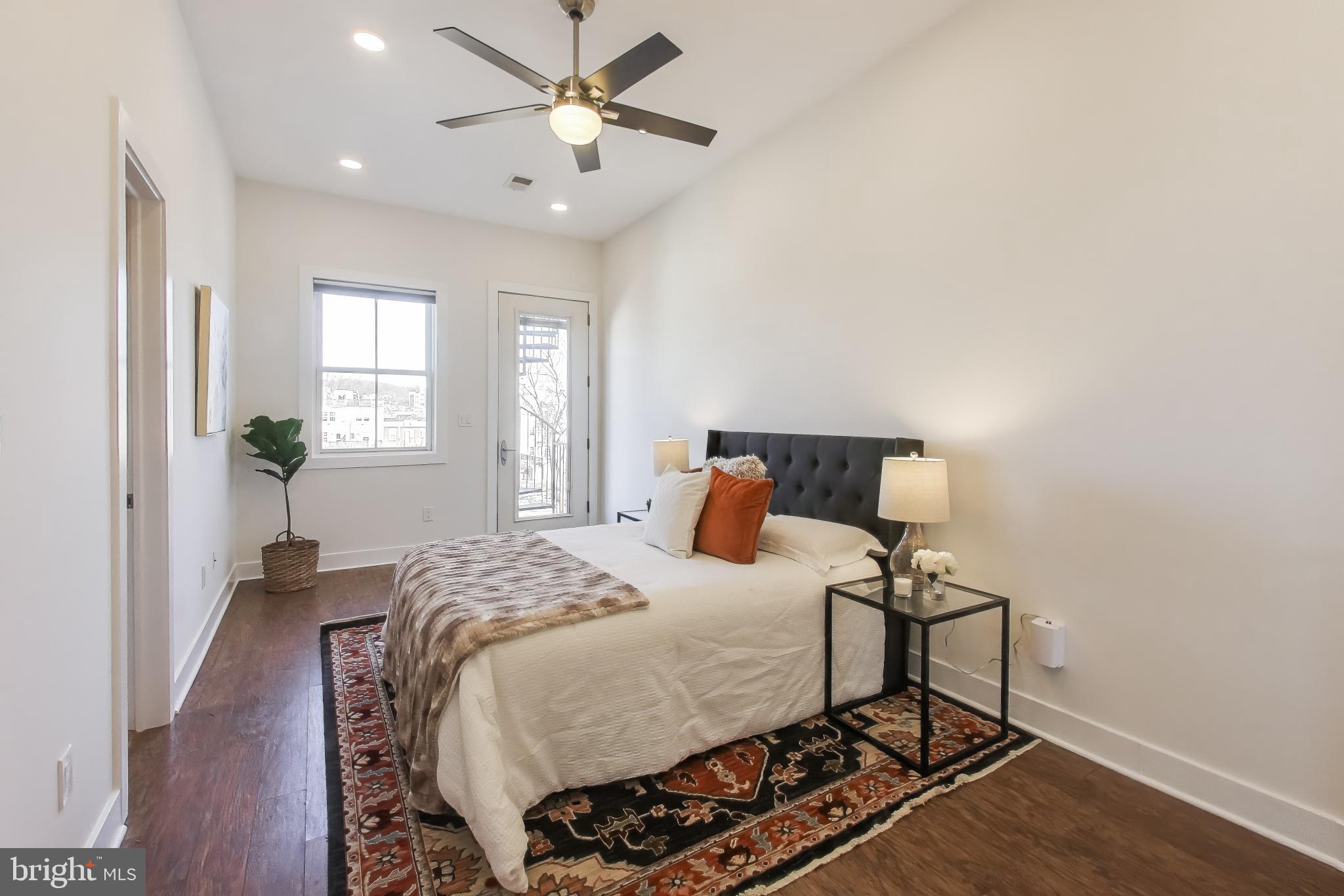 2012 D Street Northeast, Unit 4 Washington, DC 20002 - Photo 12 of 25 a bedroom with a bed and wooden floor