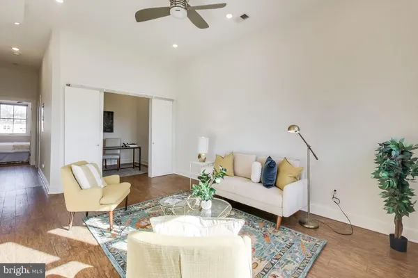 a living room with furniture and wooden floor