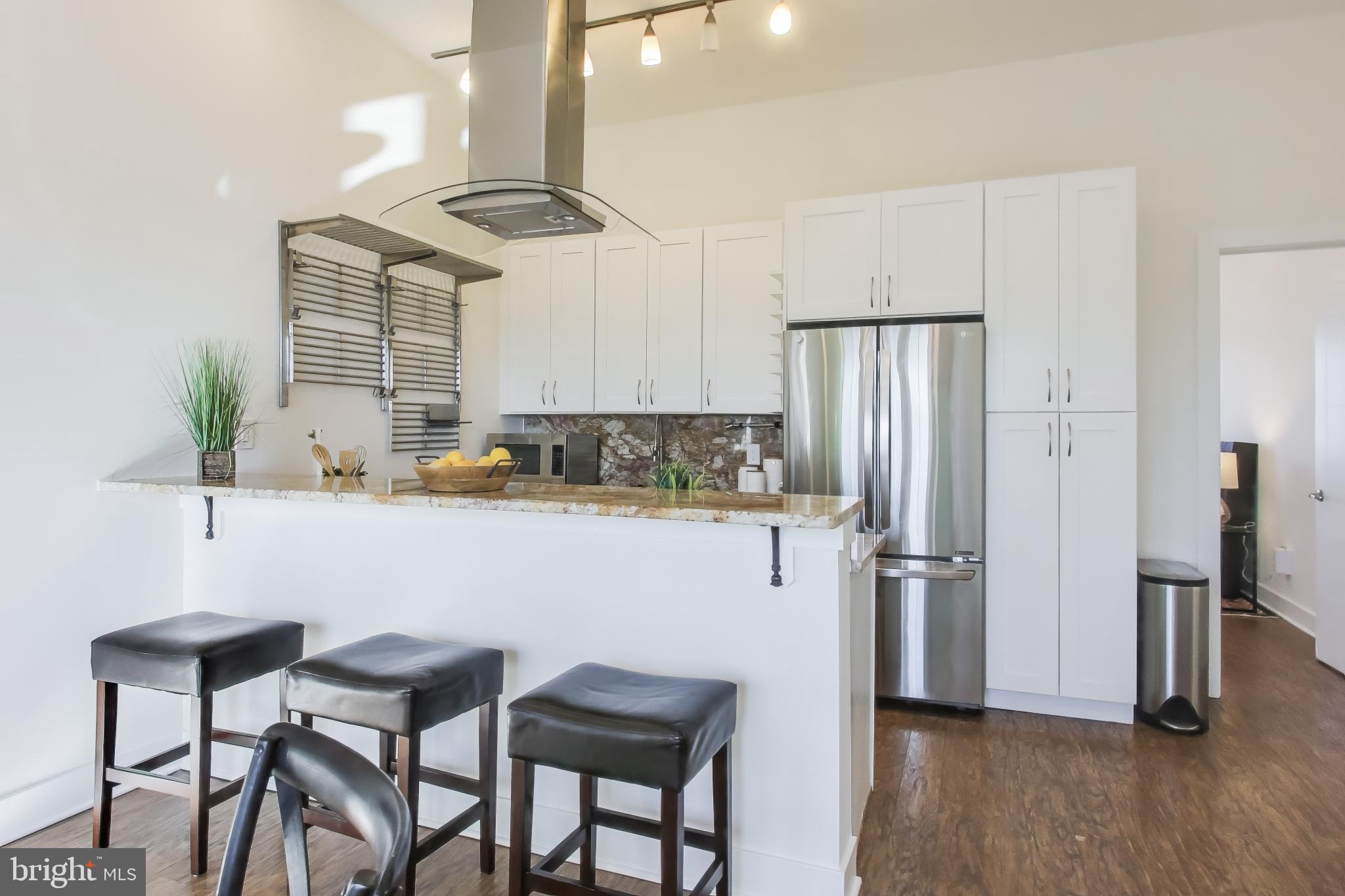 2012 D Street Northeast, Unit 4 Washington, DC 20002 - Photo 5 of 25 a kitchen with stainless steel appliances a refrigerator and a table