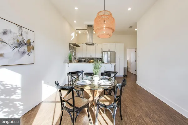 a view of a dining room with furniture and wooden floor