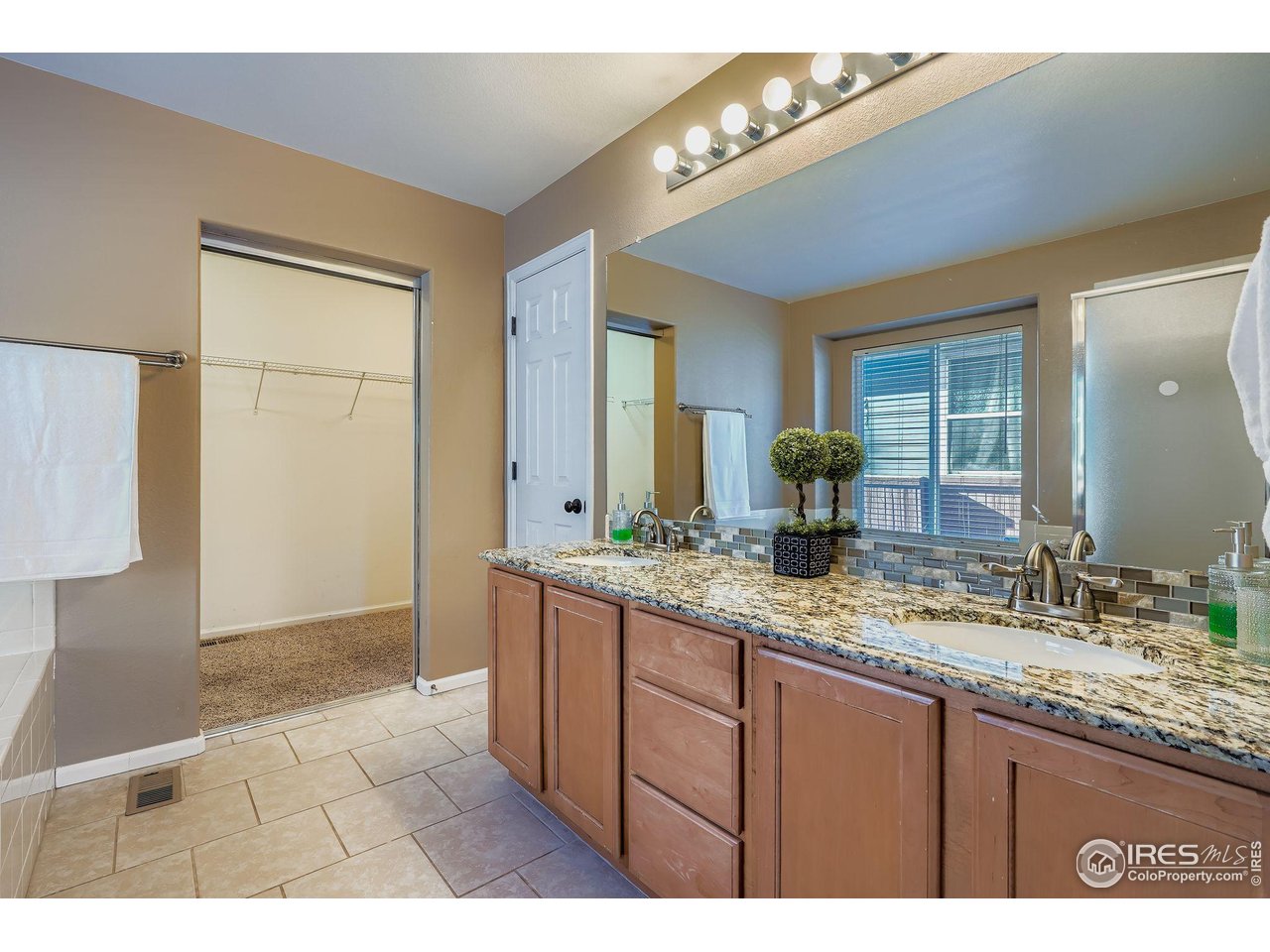 2011 Alpine Drive Erie, CO 80516 - Photo 13 of 21 a bathroom with a granite countertop sink a mirror and a