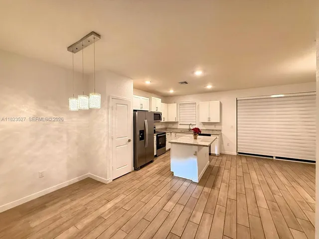 a view of a kitchen with wooden floor