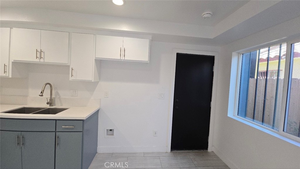 10415 1/2 Avalon Boulevard Los Angeles, CA 90003 - Photo 12 of 24 a kitchen with a sink and cabinets