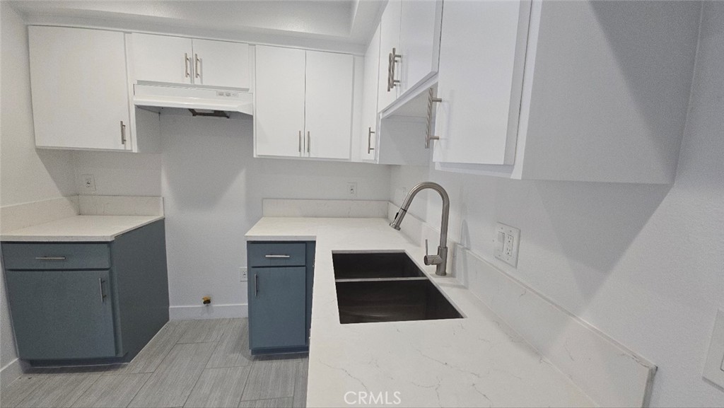 10415 1/2 Avalon Boulevard Los Angeles, CA 90003 - Photo 16 of 24 a kitchen with stainless steel appliances a sink a stove and cabinets