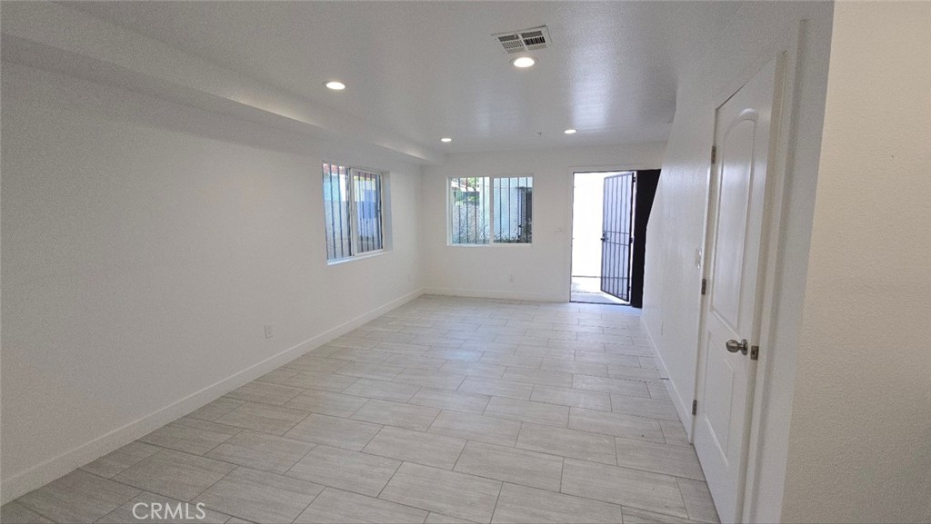 10415 1/2 Avalon Boulevard Los Angeles, CA 90003 - Photo 17 of 24 a view of a hallway with wooden shelves