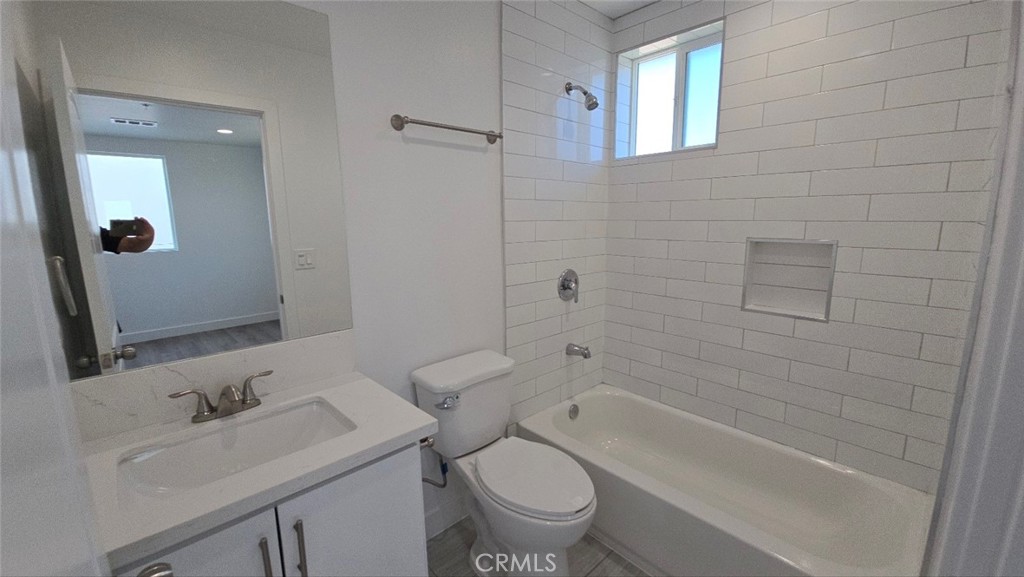 10415 1/2 Avalon Boulevard Los Angeles, CA 90003 - Photo 21 of 24 a bathroom with a toilet sink vanity tub and shower