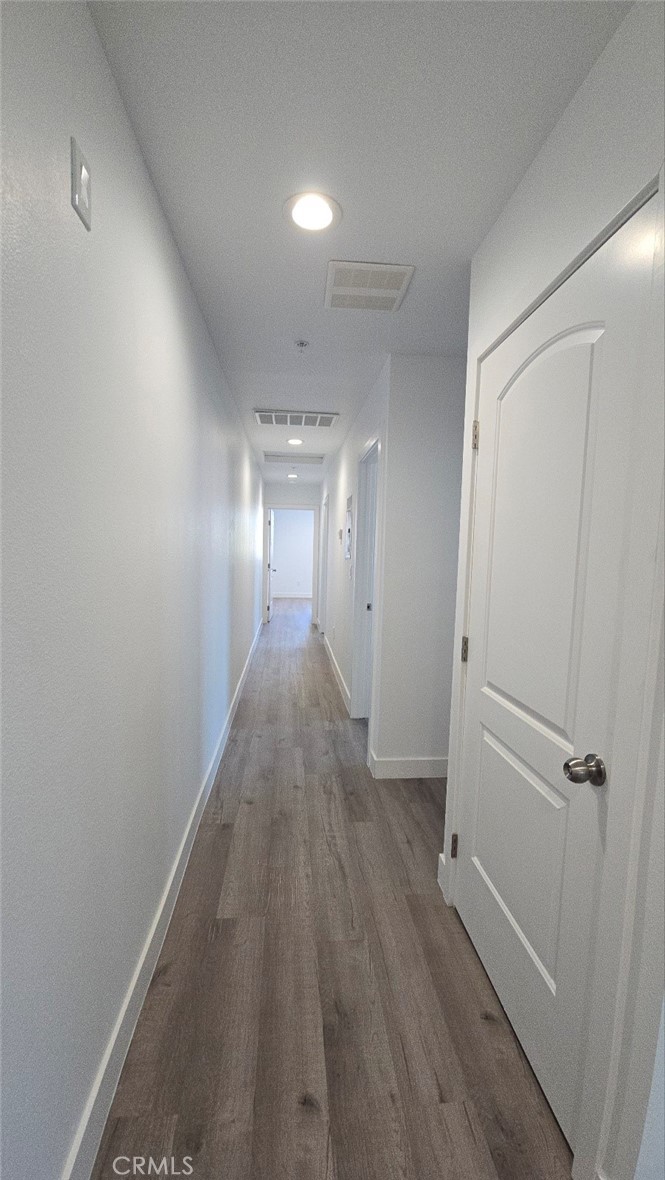 10415 1/2 Avalon Boulevard Los Angeles, CA 90003 - Photo 22 of 24 a view of a hallway with wooden floor