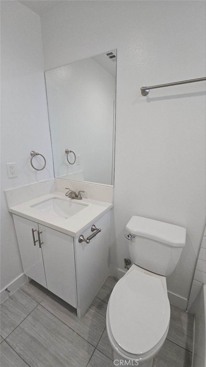 10415 1/2 Avalon Boulevard Los Angeles, CA 90003 - Photo 23 of 24 a bathroom with a sink mirror vanity and toilet