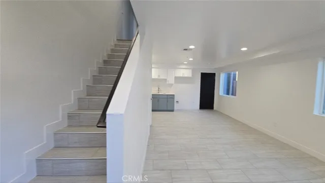 a kitchen with cabinets appliances a sink and a counter top space