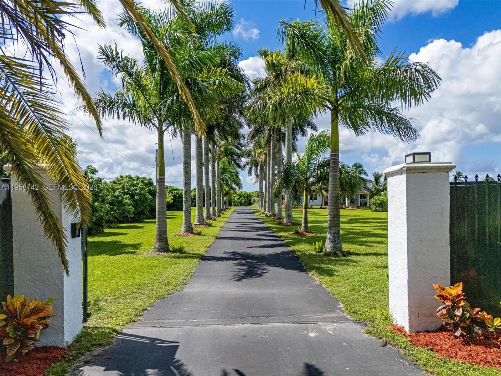 20520 Southwest 190th Street Miami, FL 33187 - Photo 2 of 39 a front view of a house with a yard and fountain