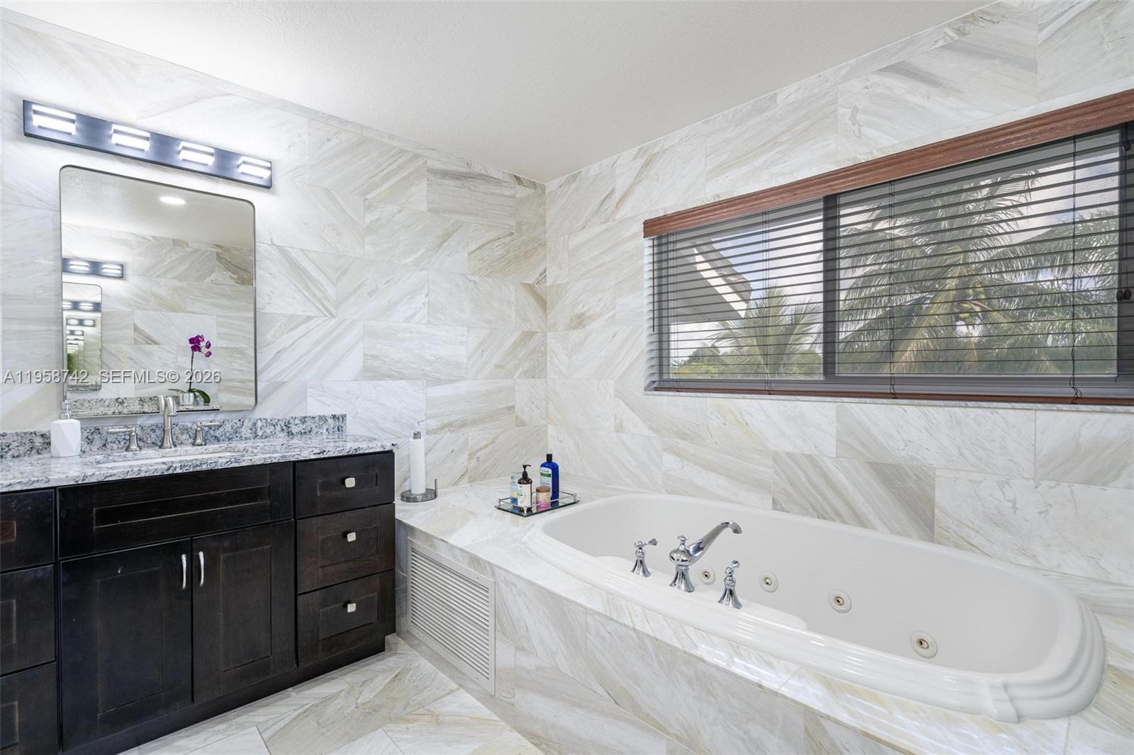 20520 Southwest 190th Street Miami, FL 33187 - Photo 22 of 39 a bathroom with a tub sink and mirror