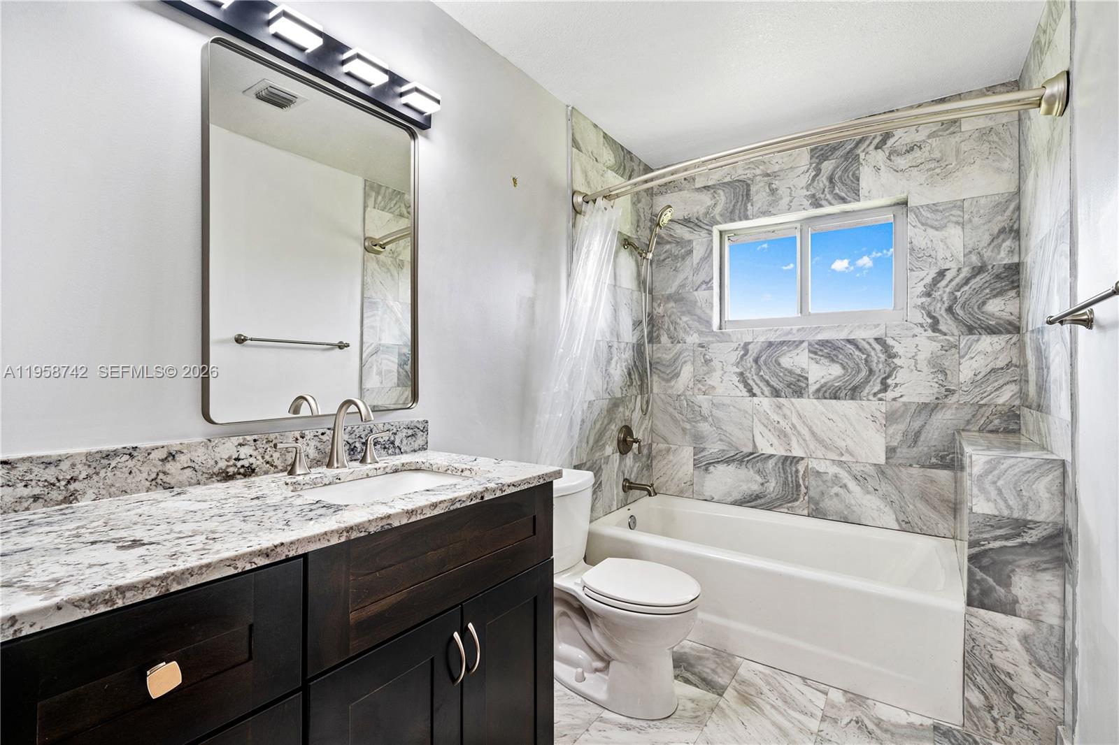 20520 Southwest 190th Street Miami, FL 33187 - Photo 25 of 39 a bathroom with a granite countertop sink toilet and shower