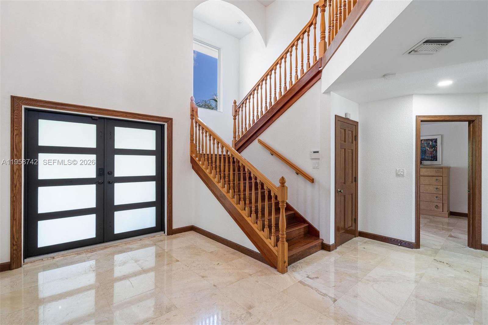 20520 Southwest 190th Street Miami, FL 33187 - Photo 7 of 39 a view of staircase with lots of frames on wall and a window