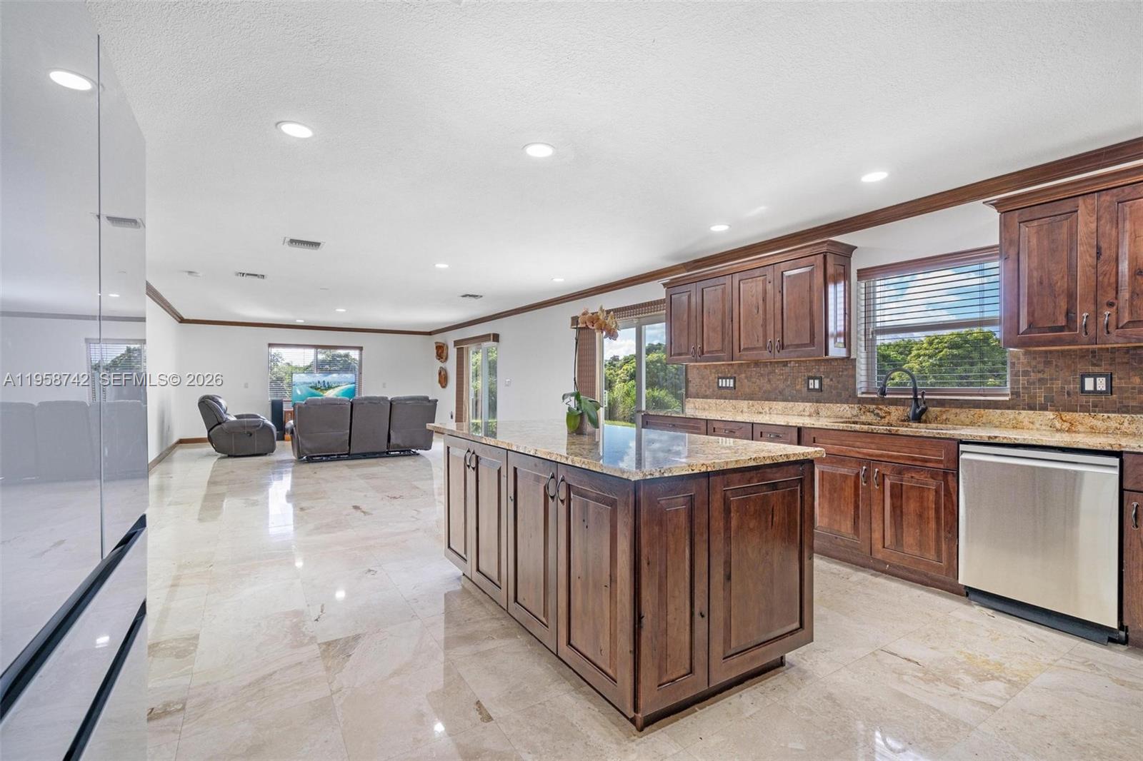 20520 Southwest 190th Street Miami, FL 33187 - Photo 10 of 39 a kitchen with stainless steel appliances granite countertop a refrigerator a sink dishwasher and a stove with wooden cabinets