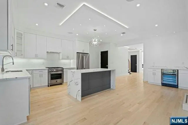 a kitchen with appliances cabinets and a sink