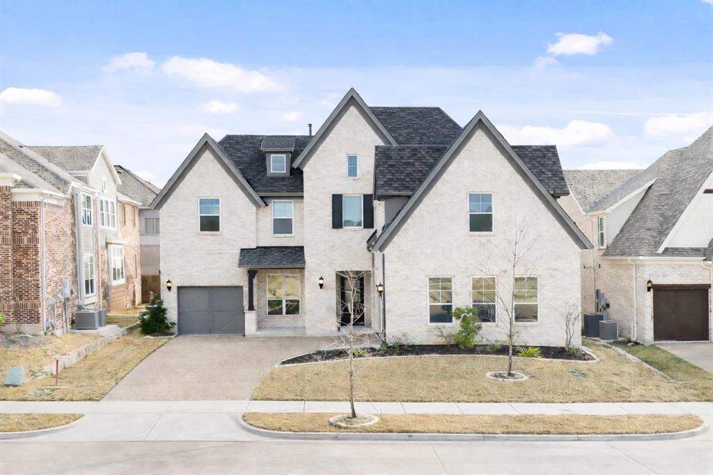 a view of a white house with a yard and large tree