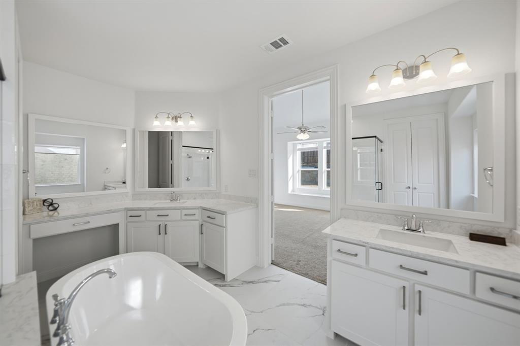 1227 Calebria Way Fate, TX 75087 - Photo 11 of 34 a bathroom with a sink and a mirror