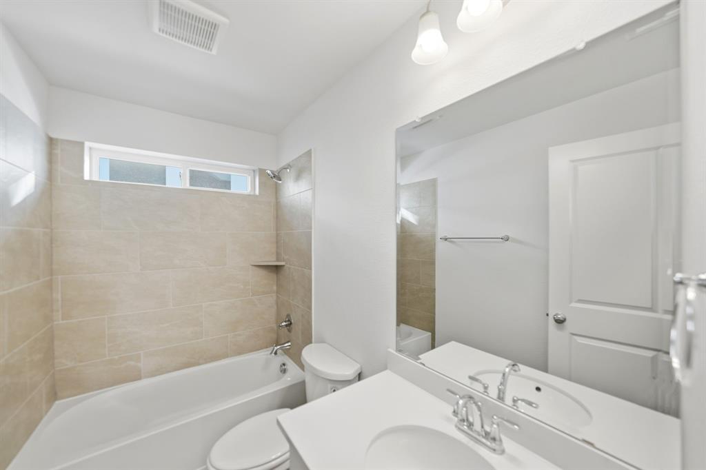 1227 Calebria Way Fate, TX 75087 - Photo 19 of 34 a bathroom with a sink and a bathtub