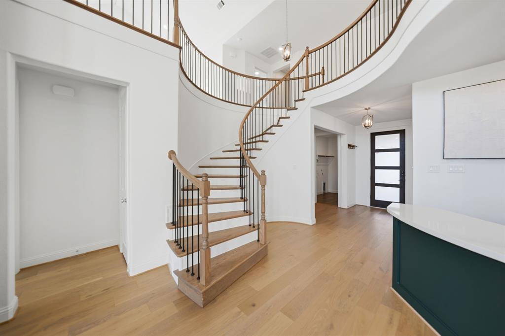 1227 Calebria Way Fate, TX 75087 - Photo 2 of 34 a view of entryway with stairs and wooden floor