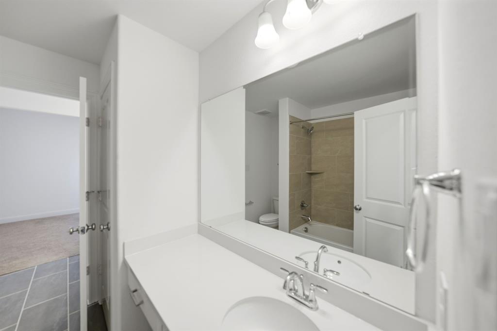 1227 Calebria Way Fate, TX 75087 - Photo 21 of 34 a bathroom with a sink and a mirror