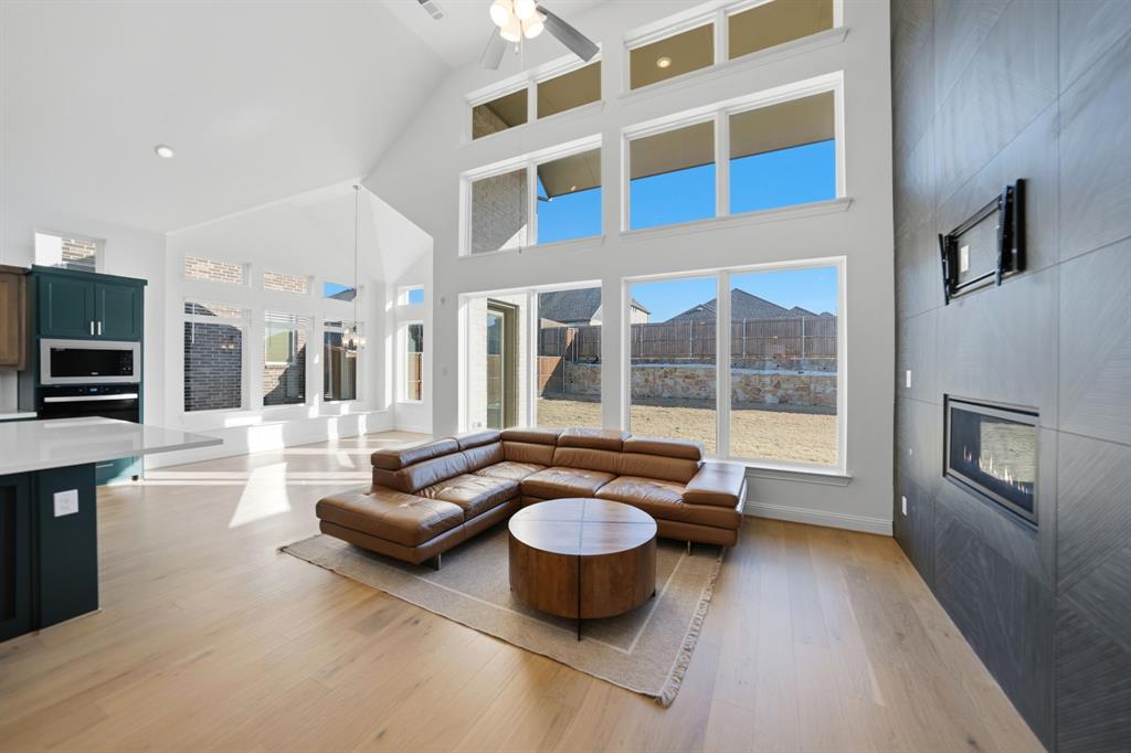 1227 Calebria Way Fate, TX 75087 - Photo 3 of 34 a living room with furniture and a fireplace