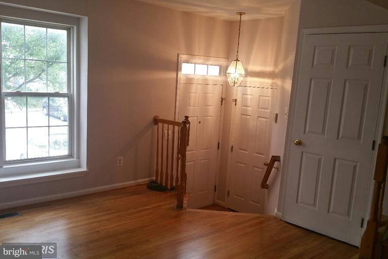 6367 Racetec Place Springfield, VA 22150 - Photo 3 of 25 an empty room with wooden floor and a window